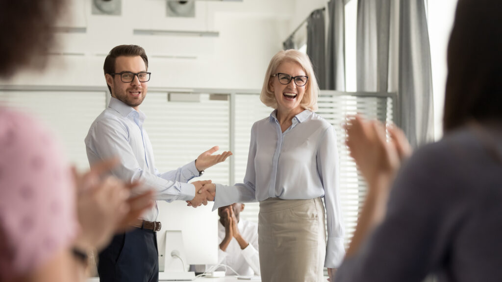 Happy manager boss praising old employee get team appreciation.